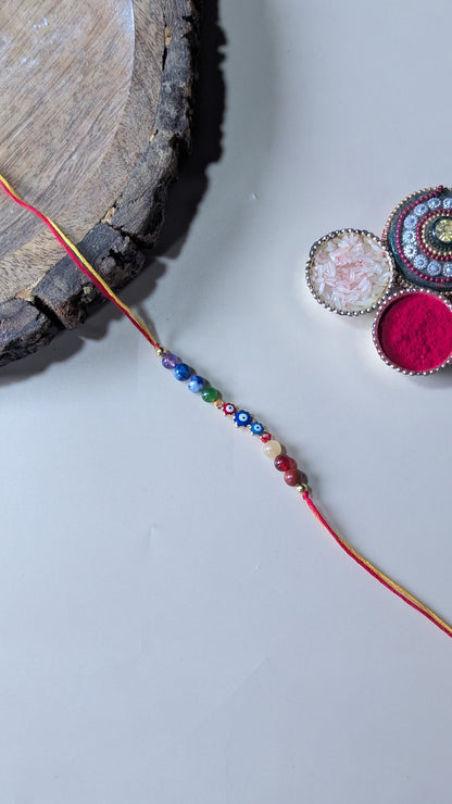 Triple evil eye rakhi with 7 chakra 6mm beads-Flower-Maitri Export | Crystals Store