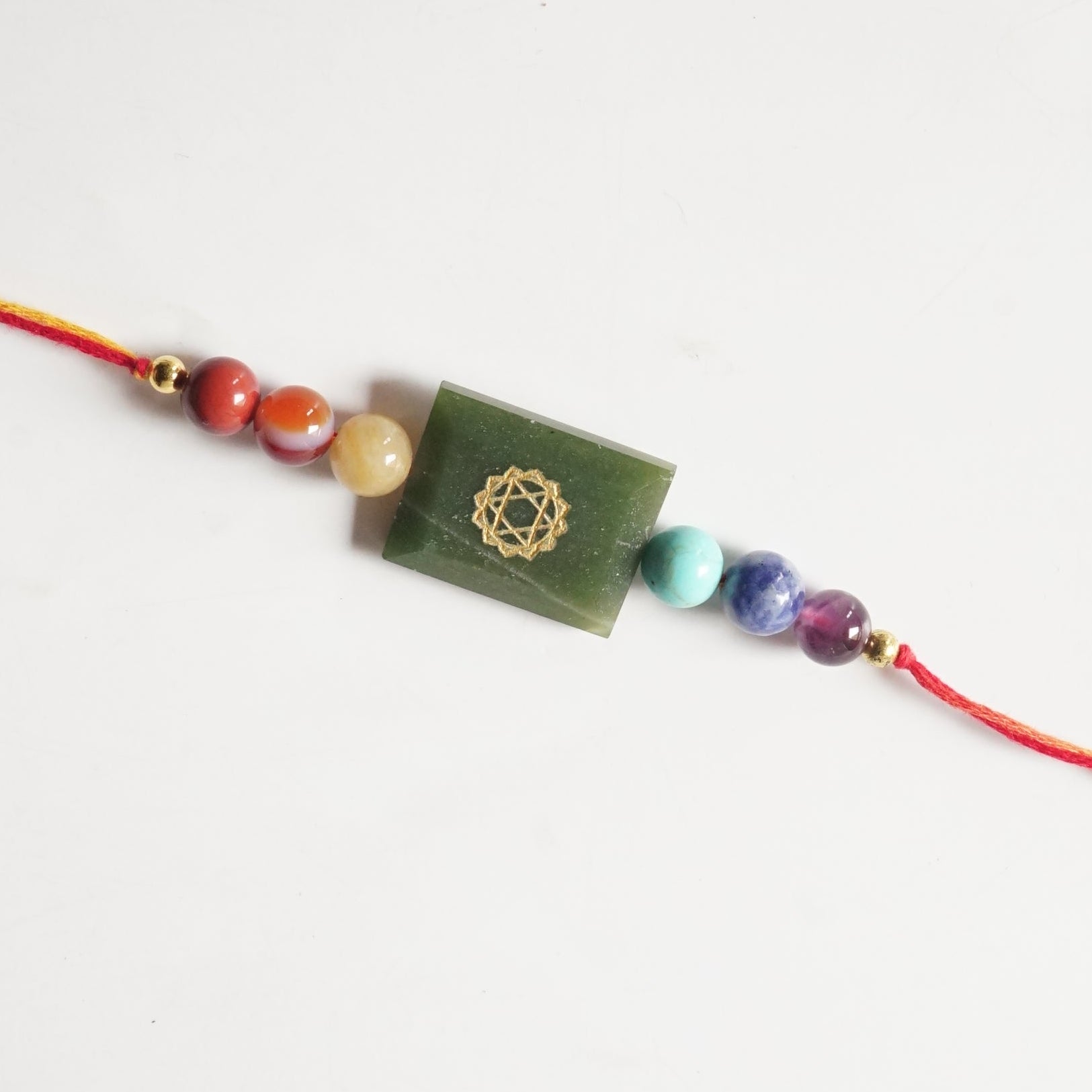 7 chakra with each chakra symbol rakhi-Green jade-Maitri Export | Crystals Store