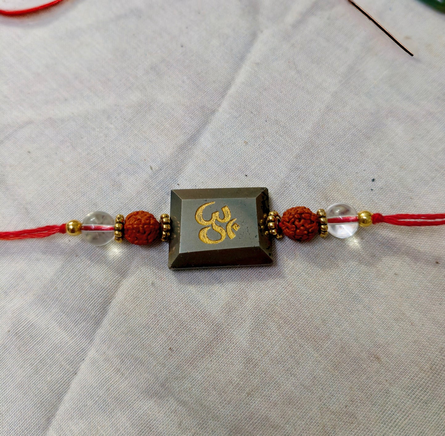 Pyrite centerpiece with rudraksh and clear quartz rakhi-Om-Maitri Export | Crystals Store