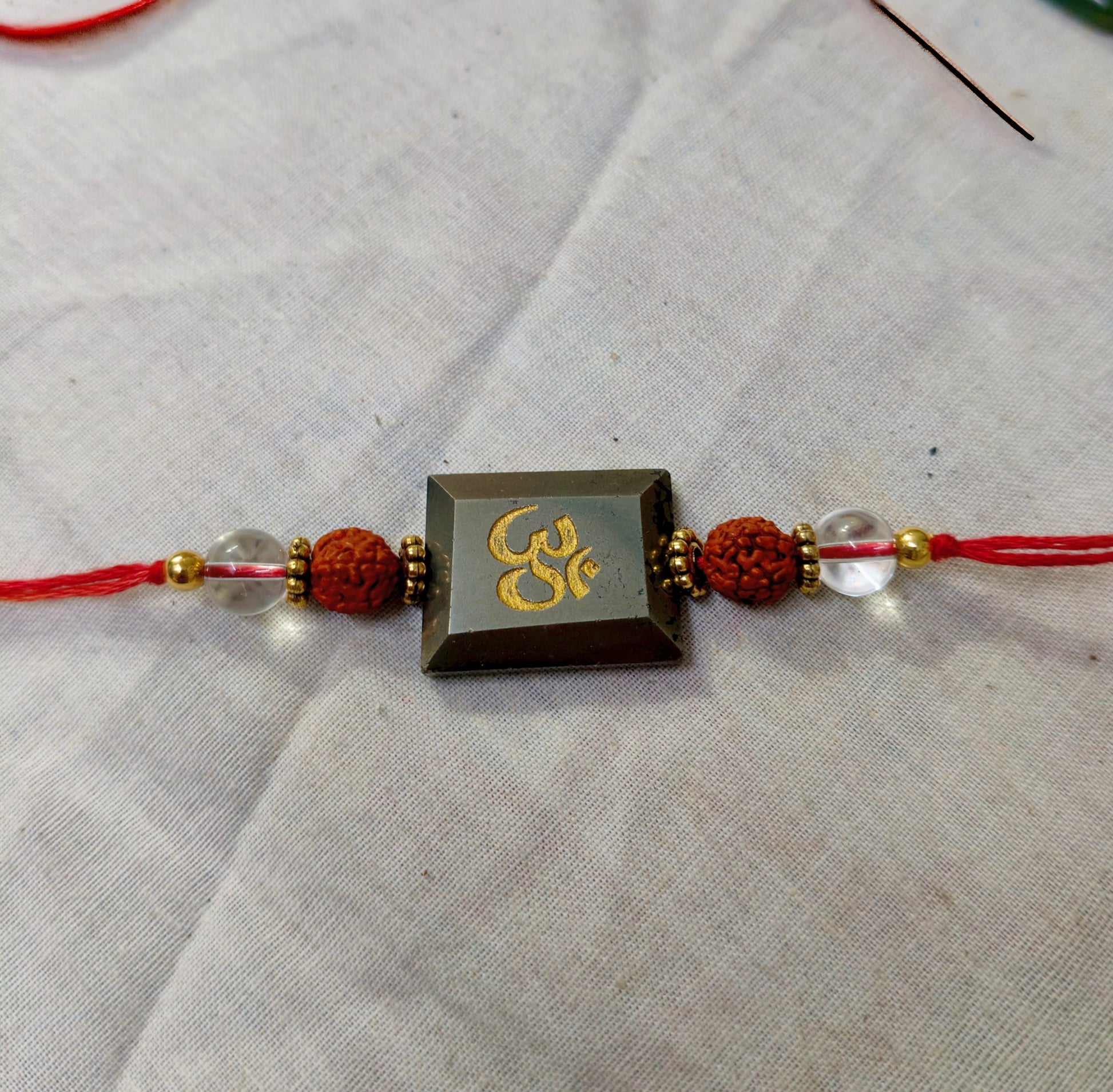 Pyrite centerpiece with rudraksh and clear quartz rakhi-Om-Maitri Export | Crystals Store